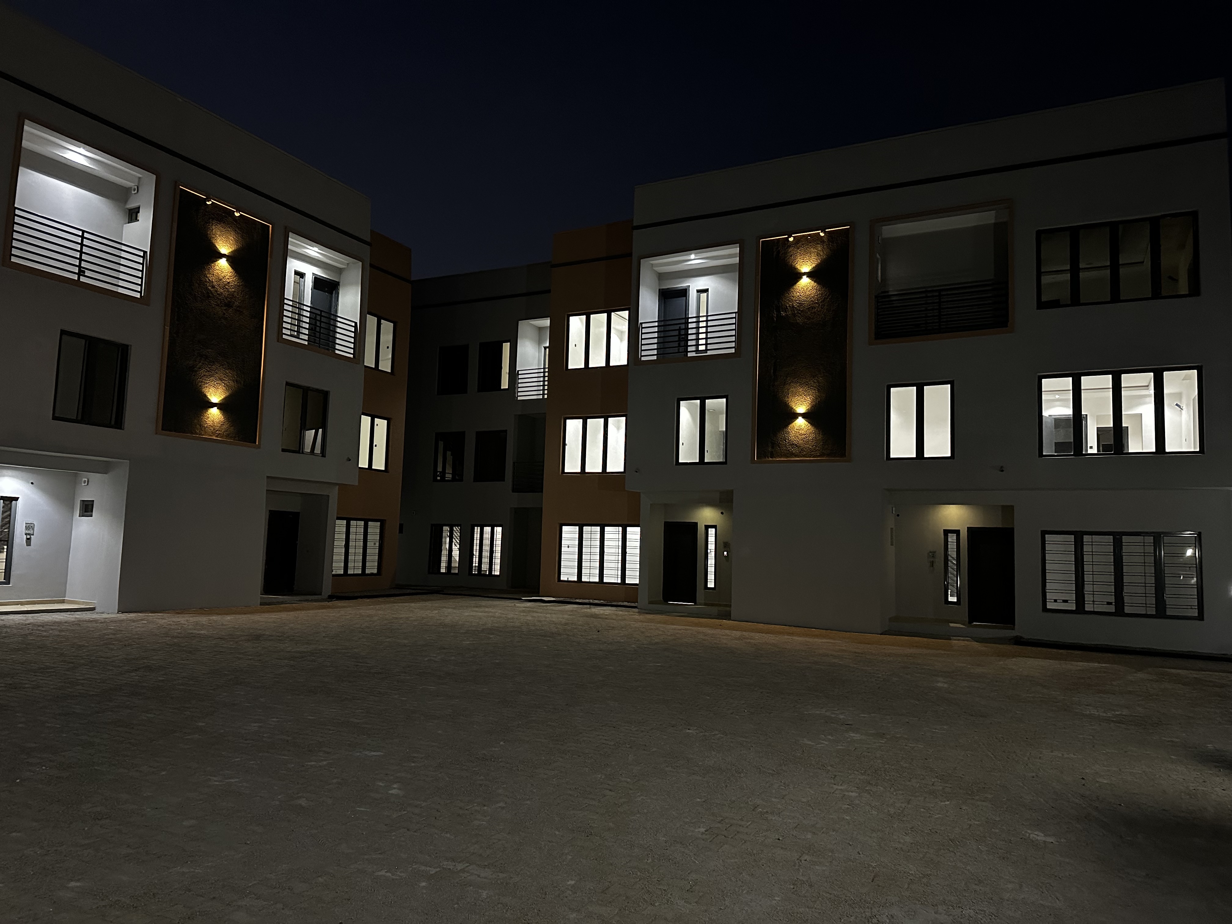 Illuminated completed Andrews Court townhouses around a private residential courtyard